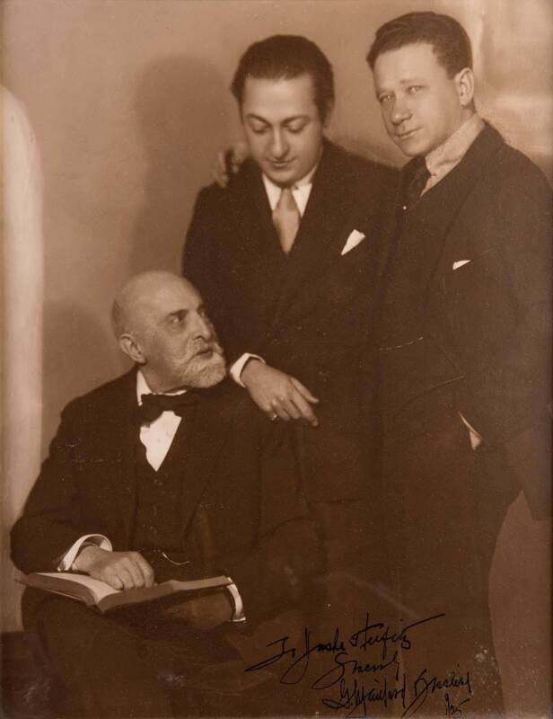 Framed photograph of Leopold Auer with his former pupils, Jascha Heifetz and Efrem Zimbalist; endorsed to Heifetz and dated "1/25" by the photographer (indecipherable signature). 47 x 37cm. Leopold Auer [1845-1930] - violinist, pedagogue, conductor and co