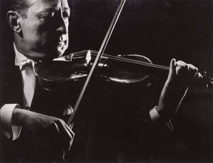 Gjon Mili [1904-1984] original silver gelatin print photograph of Heifetz performing; with studio stamp on reverse. 