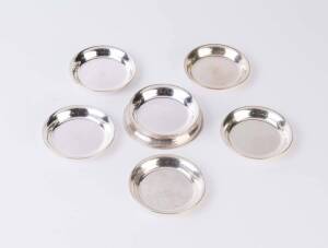 A sterling silver set of five drink coasters and coaster/holder, all engraved with initials "JH"; 10cm diameter, 335 grams. (6 items). Heifetz had had a prized and custom-designed cork coffee table which a prominent guest had scarred with an uncoastered g
