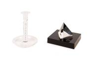 A Steuben crystal desk ornament on a black lucite base and a Steuben candle holder with attached saucer, 20th century;&nbsp;the candlestick 15cm high.&nbsp;A gift from Heifetz to his wife, Frances, and prominently displayed on a side-table next to her reading chair