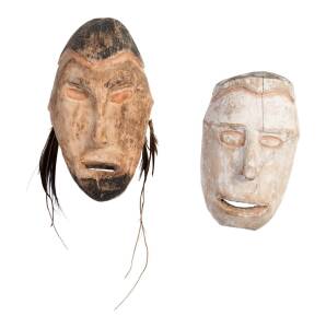 Two Asmat carved wooden ancestor heads; carved wood, rattan, shells, feathers and natural pigments; 28 cm; 22 cm long. Asmat tribal village, early 1990s.