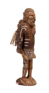 An Asmat carved wooden figure of mother and child; carved wood, natural fibres and natural pigments; 47 cm high.Asmat tribal village, early 1990s.