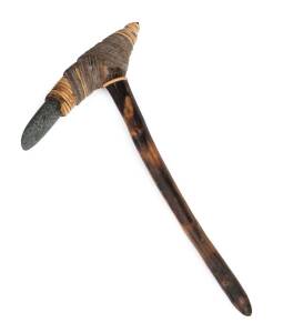 An Adze, formed of carved wood, woven rattan and stone; 54 cm long.Dani tribal village, acquired early 1990s.