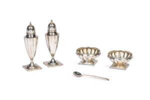 A Tiffany & Co sterling silver cruet and a silver plate salt spoon,the cruet comprising pairs of fluted pepper casters and salts; engraved initials "JH", No. 15277A/2849 and 4771A/5853; 12 cm & 6.5 cm diameter. (5 items).Purchased by Heifetz and his first