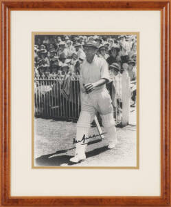 DON BRADMAN, lovely signature on sepia photograph of Bradman walking out to bat c1938, window mounted, framed & glazed, overall 33x39cm.