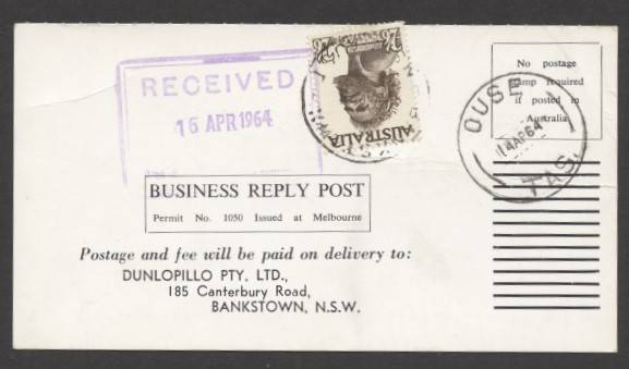 Commonwealth Postal History - 1964 Dunlopillo business reply postcard returned unfranked as intended with €˜OUSE/14AP64/TAS.€™ cds and 2/6d Aborigine affixed tied €˜BANKSTOWN/18AP64/N.S.W-AUST€™ d/s to pay 5d domestic postcard rate plus 1d business reply