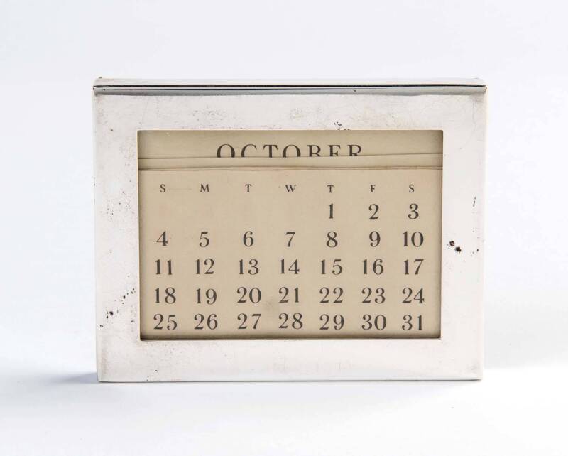 A Tiffany & Co sterling silver rectangular desk perpetual calendar; 7.5cm high.