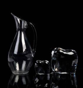 A Baccarat crystal water pitcher and two Baccarat crystal elephant ornaments the larger elephant 13cm high