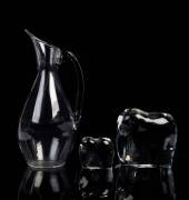 A Baccarat crystal water pitcher and two Baccarat crystal elephant ornaments&nbsp;the larger elephant 13cm high
