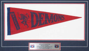 MELBOURNE: 1964 VFL Premiers display comprising "The Mighty Demons" pennant, window mounted with details of 1964 Grand Final victory, framed & glazed, overall 70x51cm.