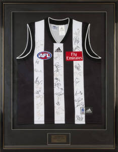 COLLINGWOOD: Collingwood Football Jumper signed by members of 2004 team, 30 signatures including Nathan Buckley, Alan Didak & Paul Licuria, window mounted, framed & glazed, overall 80x104cm.