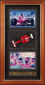 MICHAEL SCHUMACHER, display comprising signed photograph, window mounted with 1/18th scale model of his Ferrari F1-2001, framed & glazed, overall 51x95cm. With CoA.