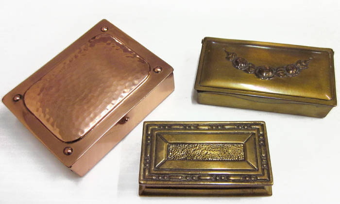 STAMP BOXES; Cast brass box, 7.5 x 3.7 x 2.2cms, with 2 divisions and an attractive geometric pattern lid; a brass box, 8 x 3.9 x 2cms with 3 divisions and an 'art noveau' style lid and a copper box, 8 x 6 x 2.5cms, similar to the previous item with 3 div