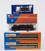 MODEL RAILWAYS: ROCO: DB BR 53 Series Guterzug Steam Locomotive with Tender (4112) with Rolling Stock Comprising of SBB 1st Class Passenger Car (44346), SBB 2nd Class Passenger Car (44349), DR Baggage Car. All mint in original cardboard packaging. (4 item