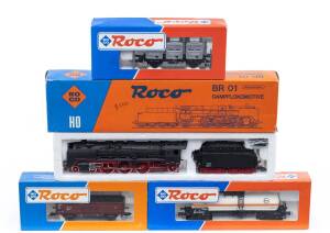 MODEL RAILWAYS: ROCO: DR BR 4-6-2 Class BR 01 Steam Locomotive with Tender (04119C), with Rolling Stock Comprising DB Tank Car ‘EVA’ (46072), DB Open Freight Car (46010), DB Container Car (46524). All mint in original cardboard packaging. (4 items)