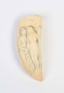 A scrimshaw whale's tooth with carving of three women
