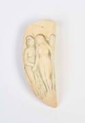 A scrimshaw whale's tooth with carving of three women