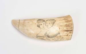 A scrimshaw whale's tooth with female portraits