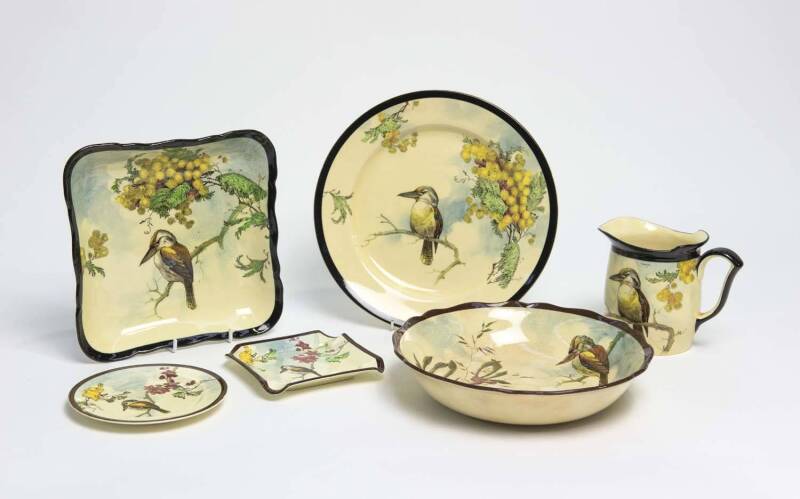 ROYAL DOULTON Kookaburra porcelain set comprising circular plate, square plate, milk jug, circular bowl, small circular plate and square ashtray, circa 1922