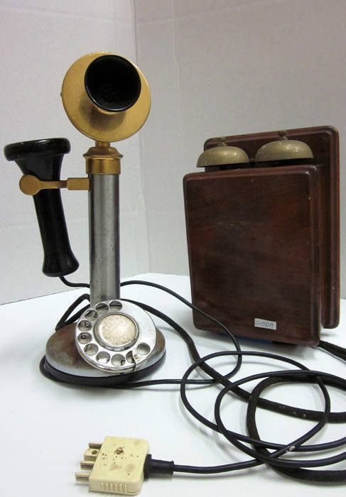 CANDLE STICK PHONE. Nickel plated base and column (some pitting), brass head piece and side arm with original bakelite ear piece. Stamped "29:CB.1" on the mouth piece. Timber cased bell box with 2 brass bells. Plus a vintage black bakelite technicians han