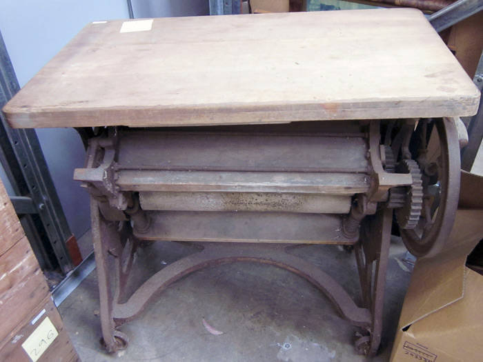 Antique mangle by "Taywil", cast iron and kauri pine on heavy iron wheels. Early 20th century, rustic farm shed state.