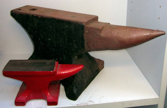 Anvil, small size cast iron with painted finish (40cm) plus a miniature modern red finished anvil. VG condition.