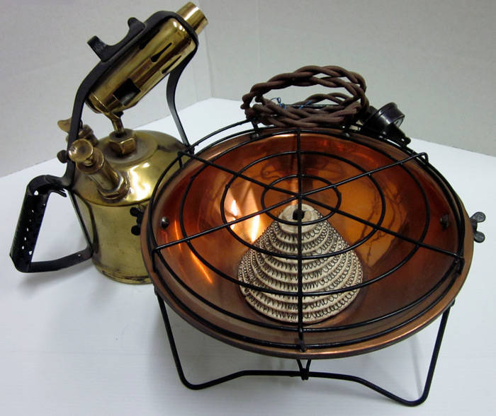 Assorted lot containing Vintage electric heaters (2), Tilley lamp, Blow torch, Rega spray pumps (3) and a Coleman portable stove (boxed). A nice collection of brass, copper and old wares. G/VG condition.