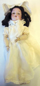ARMAND MARSEILLE German porcelain headed doll with crying noise (c1920). Headed stamped "A 390 M". Hand made white costume, Human hair and painted wooden limbs. Good condition.