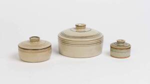 HAROLD HUGHAN Graduated group of three lidded pots  