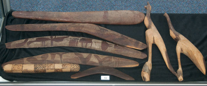 Aboriginal Artifacts, mid-20th Century, collected in the Coober Pedy district by an opal prospector. 3 Boomerangs, each with pecked animal and floral designs. Child's mulga wood boomerang; poker work clap stick; carved mulga wood Kangaroo and Emu. Noted: