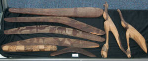 Aboriginal Artifacts, mid-20th Century, collected in the Coober Pedy district by an opal prospector. 3 Boomerangs, each with pecked animal and floral designs. Child's mulga wood boomerang; poker work clap stick; carved mulga wood Kangaroo and Emu. Noted: 