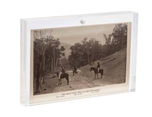 A Ned Kelly vintage postcard mounted in perspex block