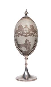 A silver plated emu egg ornament carved with horses and English coat of arms, 19th century