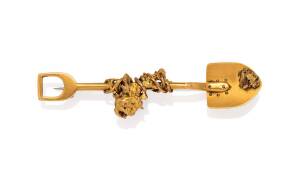 A goldfields brooch designed with a shovel and wire entwined gold nugget, circa 1890, unmarked, 9 carat yellow gold bar