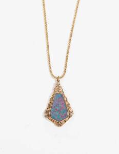 An Australian kite shaped opal doublet pendant with two coloured gold leaves and petals and chain