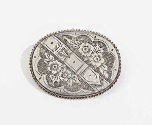 An Australian silver oval brooch by. Edward Fischer, Geelong, circa 1880 engraved with a belt and buckle among flowers, marked "E.FISCHER"4cm wide