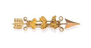 An Australian goldfields bar brooch designed as a triple bar arrow set with three gold nuggets, circa 1890, stamped "18CT", circa 1890