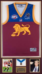 JASON AKERMANIS (Brisbane Lions), display with signed Brisbane Lions jumper, window mouted with replica Brownlow Medal & two photographs, framed & glazed, overall 75x119cm. With CoA.