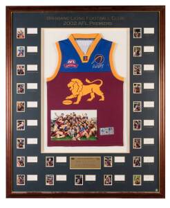 BRISBANE LIONS: 2002 AFL Premiers display with Brisbane Lions jumper, window mounted with photo of the team celebrating their Grand Final win, plus photo & signature of 23 players & coach, limited edition 201/202, framed & glazed, overall 103x124cm.