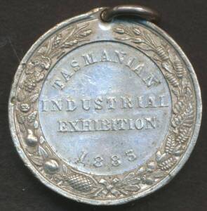 AUSTRALIA: 1883 Tasmanian Industrial Exhibition medal, Launceston, (38mm) white metal by Stokes & Martin, C# 1883/4Â holed with suspension loop, VF.