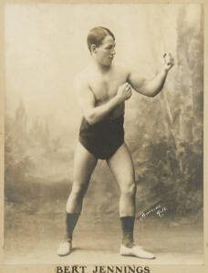 BERT JENNINGS: c1904 photograph of Bert Jennings in boxing pose, window mounted, framed & glazed, overall 59x73cm.