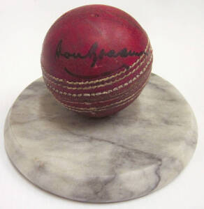 CRICKET GROUP, noted Don Bradman signed cricket ball on marble stand; signed items (16) including Don Bradman, Bill Ponsford, Gary Sobers, Douglas Jardine & J.B.Hobbs; books (3) including "Allan Border - Beyond Ten Thousand" signed by Don Bradman; c1972 W