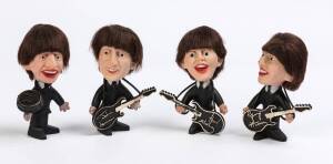 THE BEATLES: 1964 set of 4 Seltaeb (Beatles spelt backwards) figurines with instruments, each 12cm tall.