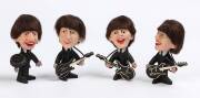 THE BEATLES: 1964 set of 4 Seltaeb (Beatles spelt backwards) figurines with instruments, each 12cm tall.