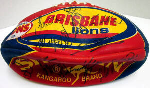 BRISBANE LIONS: Collection of memorabilia, noted signed footballs (2); Sherrin "Brisbane F.C. 2003 Premiers" football; "Premiers 2001" books (2); signed photographs (2); Prostar "Headliners" (3); Looney Tunes display; signed Andrew Bews display.