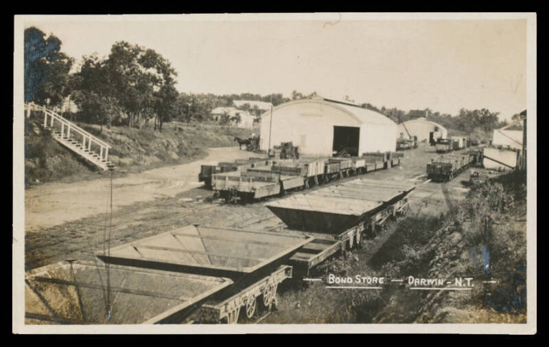 Northern Territory: Darwin: 'Bond Store' at Darwin Station real photo postcard ('Empire' back) showing Railway Sidings & empty Goods Wagons, unused, fine condition.