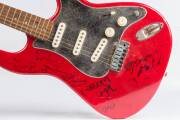 SCREAMING JETS, red 'Encore' electric guitar signed by band members Paul Woseen, Grant Walmsley, Ismet "Izzy" Osmanovic, Jimi Hocking & others; together with Roland 'Cube 15-X' amplifier. - 2