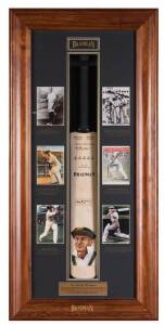 DON BRADMAN, attractive display comprising full size cricket bat with hand-painted portrait by Dave Thomas & signed by Don Bradman, mounted in display case together with 6 photos of Bradman, limited edition 227/334, overall 56x117cm.