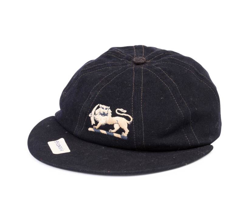 DERRICK TOWNSHEND'S RHODESIA CRICKET CAP, blue wool, embroidered Lion logo on front. Fair/Good match-worn condition. [Derrick Townshend played 5 first class matches for Rhodesia 1967-69].