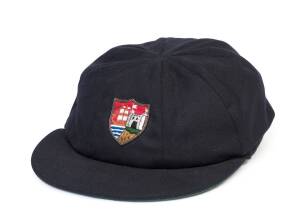 BRIAN DAVISON'S GLOUCESTERSHIRE CRICKET CAP, navy blue wool, wire embroidered Gloucestershire badge on front, named inside "Davo". [Brian Davison played 467 first class matches for Rhodesia, Leicestershire, Gloucestershire & Tasmania 1967-88].